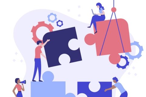 a group of people embling a puzzle